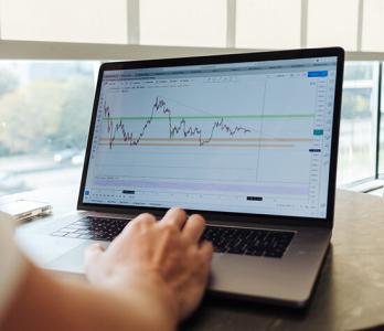 photo of a laptop with a user viewing data trends