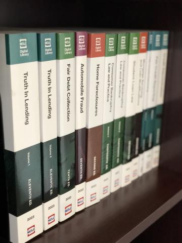 photo of several NCLC treatises on a bookshelf, their spines facing out