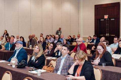 consumer law practitioners sit in a conference room at an NCLC conference